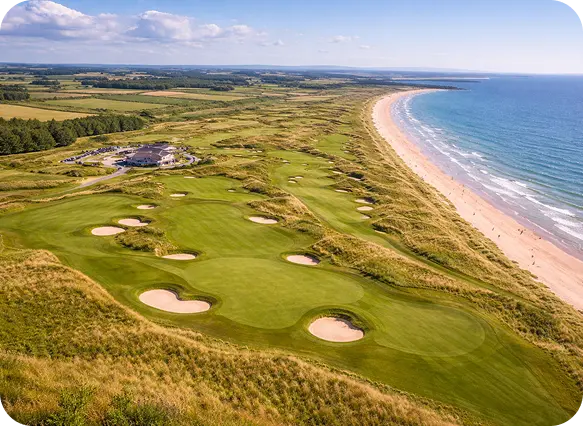 Bright, sunny aerial view of a coastal links golf course featuring green fairways, sand bunkers, and a clubhouse alongside a sweeping sandy beach and blue ocean.